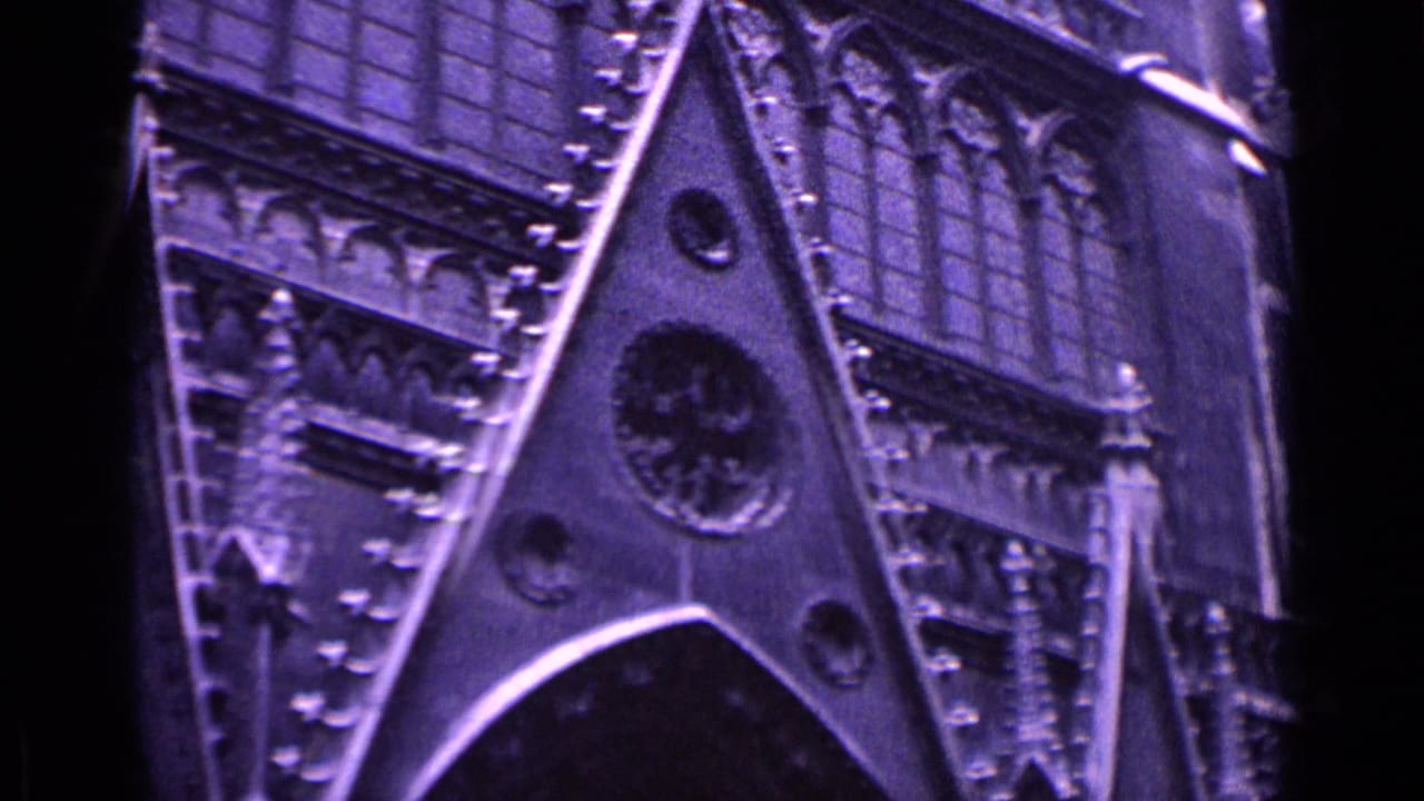 German 1962 home-movie frame showing a Gothic cathedral facade with pointed arch forms, round tracery details and vertical stone ornament.