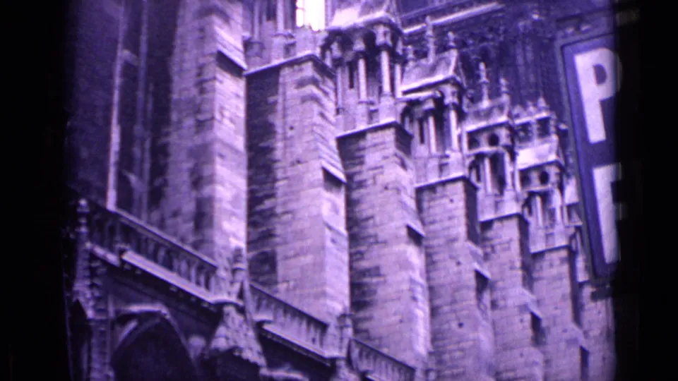 Wider 1962 German night view of a Gothic cathedral facade, showing tall masonry, carved details, arched forms and a partial sign along the right edge.