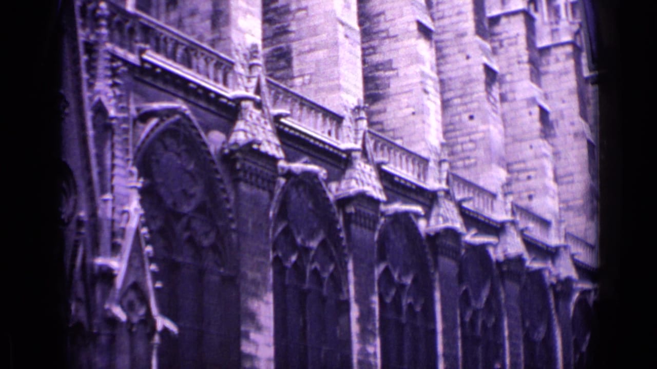 1962 Germany frame showing the side elevation of a Gothic church with tall arched windows, buttresses, and carved stone details.