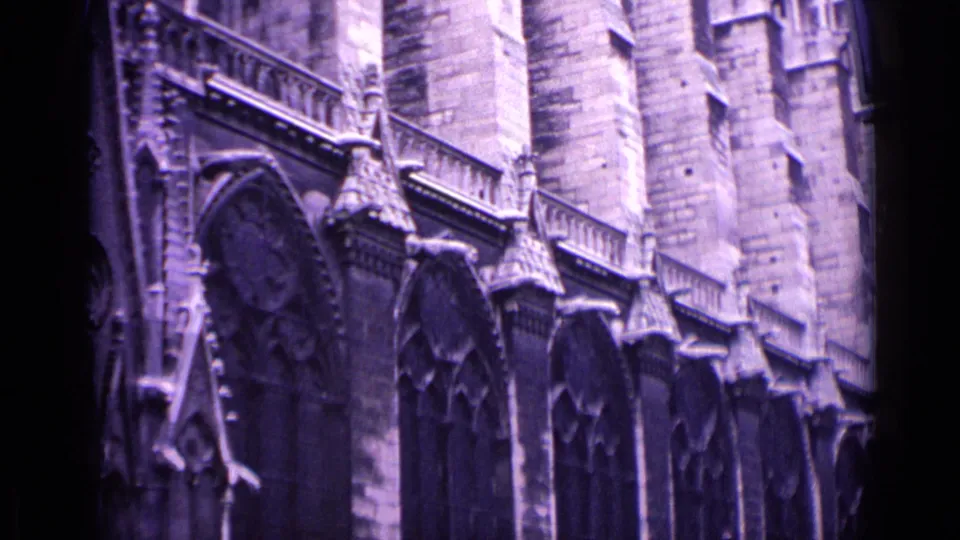 1962 Germany frame showing the side elevation of a Gothic church with tall arched windows, buttresses, and carved stone details.