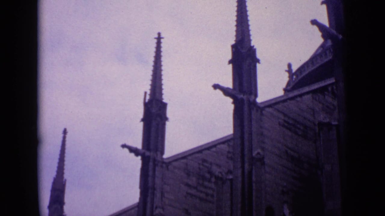 Gothic church spires and roof details against an overcast sky.