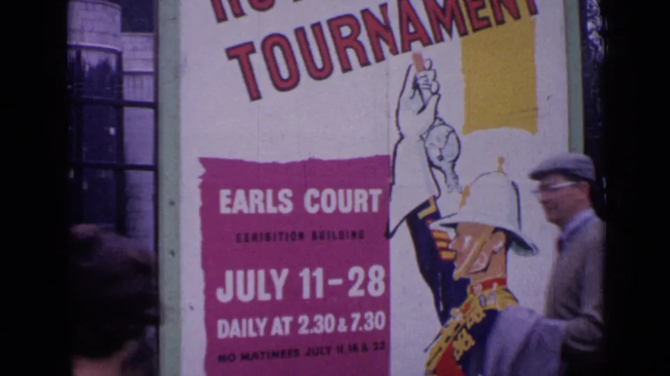 1962 London frame with a large Royal Tournament poster for Earls Court and a blurred passerby at the edge.