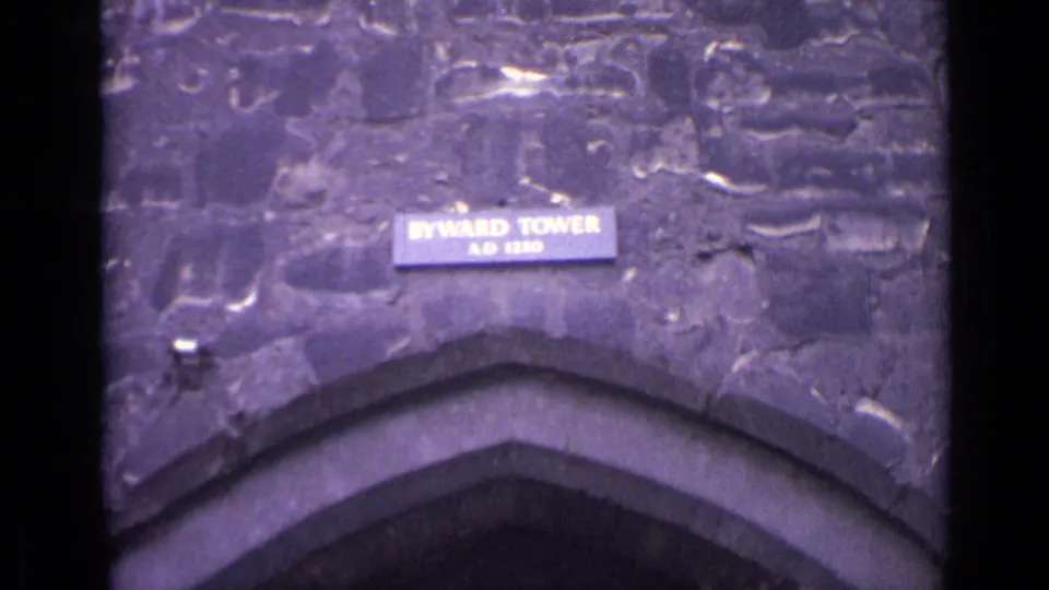 Close 1962 home-movie view of the Byward Tower sign mounted on stonework above an arched entrance.