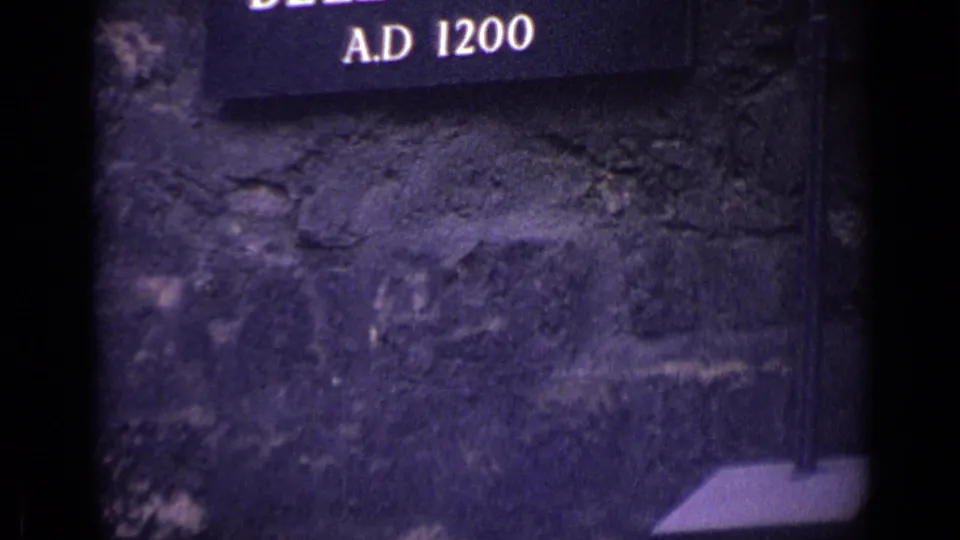 Tight 1962 London frame showing part of the Byward Tower sign reading A.D. 1280 against rough stonework.