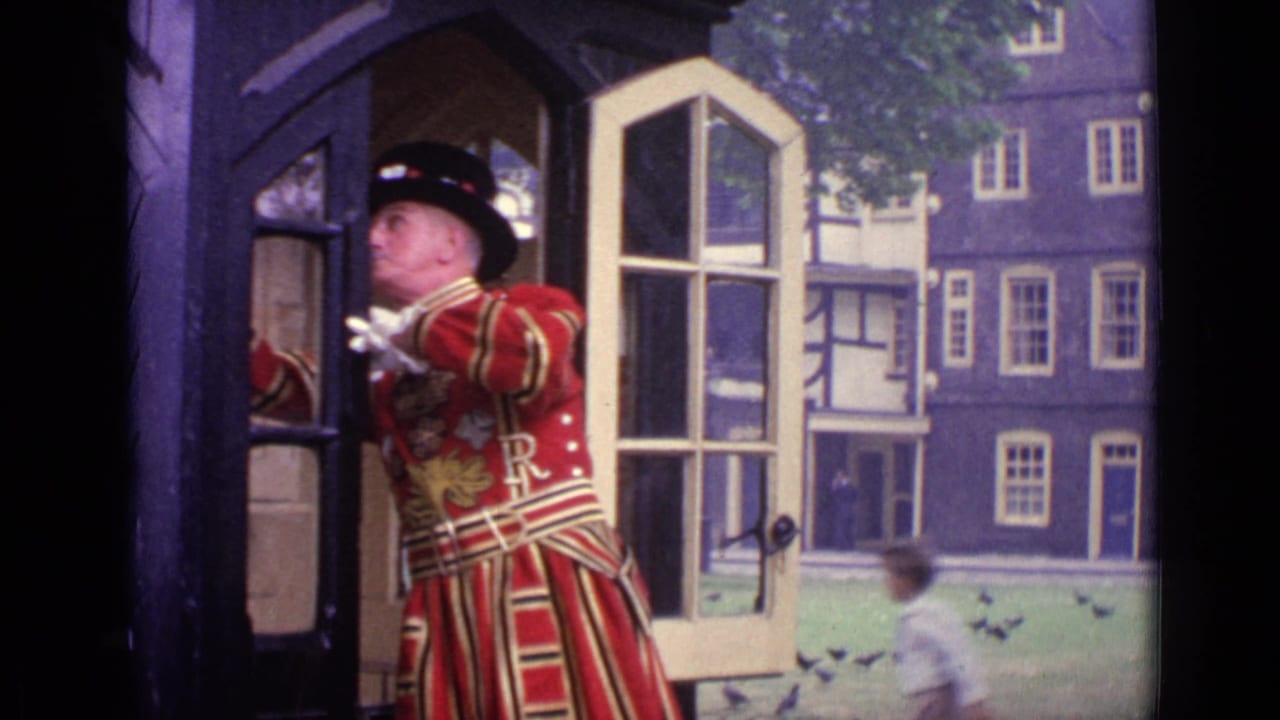 In London in 1962, a man in a red ceremonial uniform and feathered black hat stands at an open doorway overlooking a courtyard.