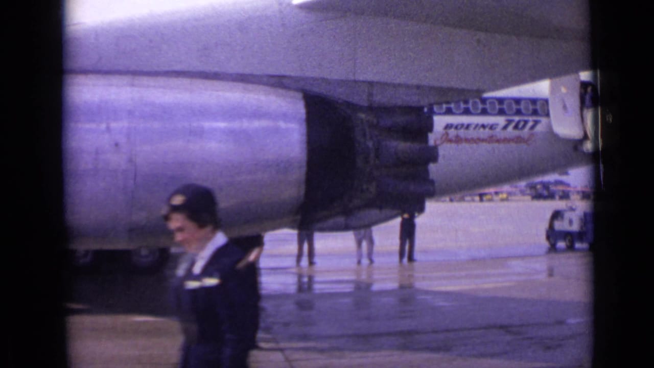 The 1962 London tarmac scene shows a flight attendant in the foreground, a Boeing 707 engine behind her, and a service vehicle at right.
