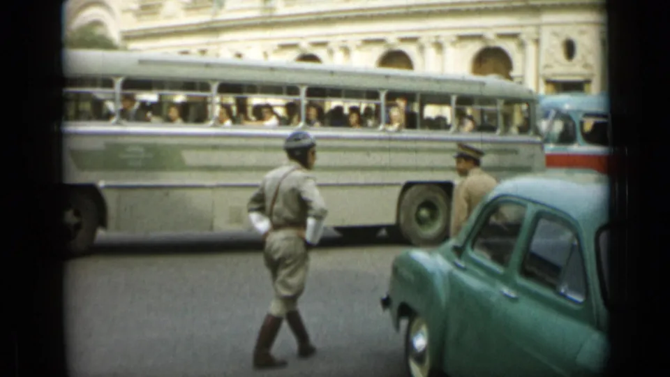 Monaco street scene with a uniformed officer, a large passenger bus, and a second uniformed figure near a green car.