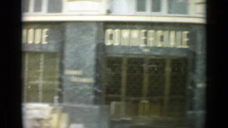 1962 Monaco street-level storefront, filmed in motion, with large lettering across windows and dark glass doors.