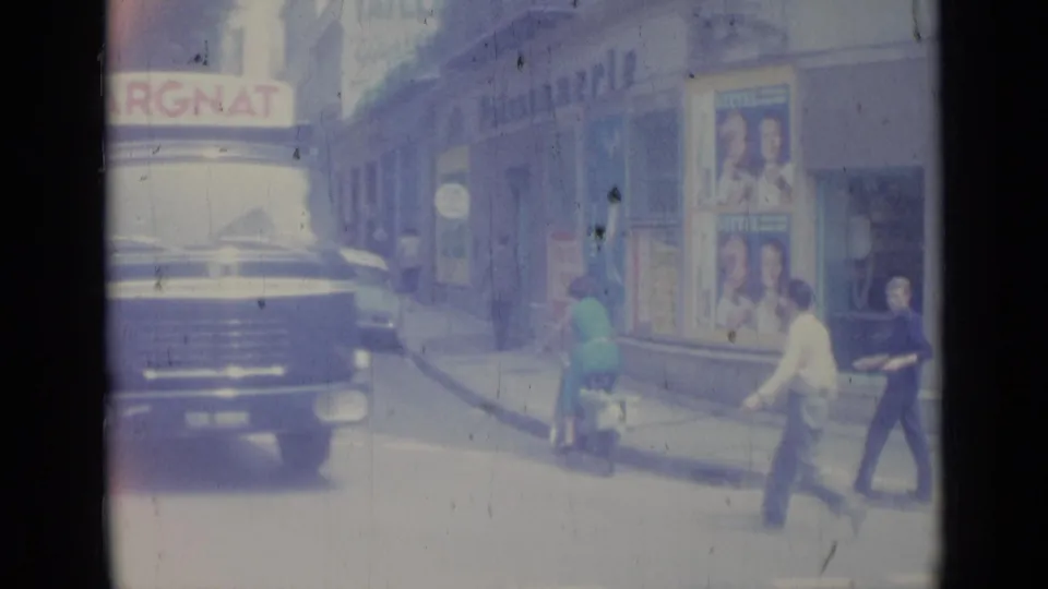 A Nice street view shows a vehicle near the curb, pedestrians, storefront posters, and a visible MARGNAT sign.
