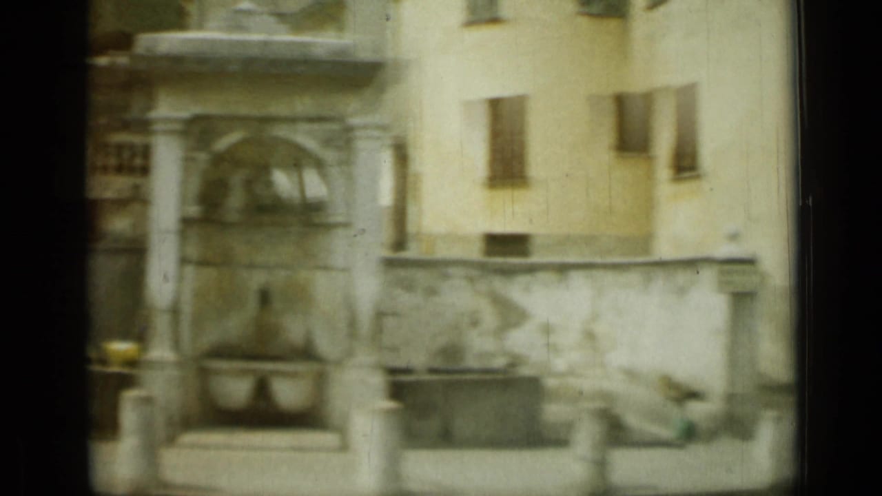 A stone fountain or wall feature in Nice, France, seen from a passing 8mm camera in 1962.