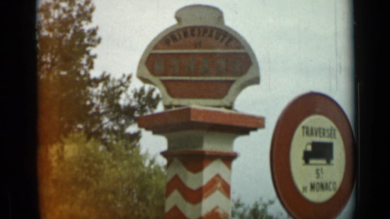 1962 French Riviera roadside view with Principaute de Monaco signage and a red 5-ton truck-limit sign.