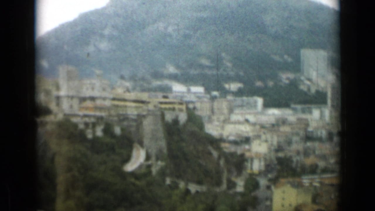 Nice, France cityscape in 1962, showing dense buildings and greenery beneath steep mountain slopes.