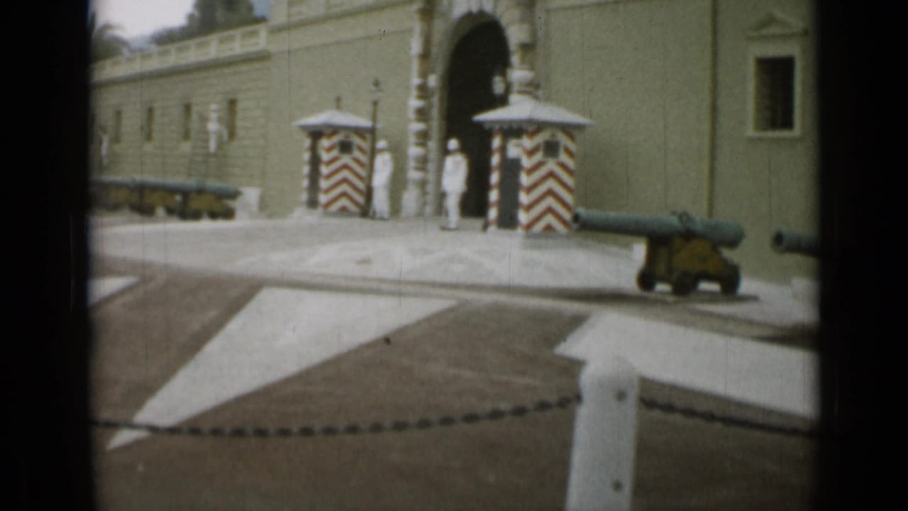 Guarded arched entrance with striped sentry boxes, cannons, and a paved forecourt.