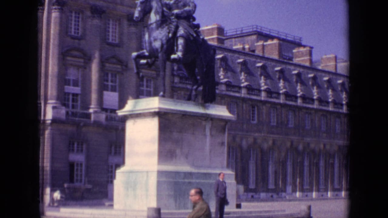 Paris 1962 frame showing an equestrian statue and large historic facade, with several adults visible in the open courtyard.