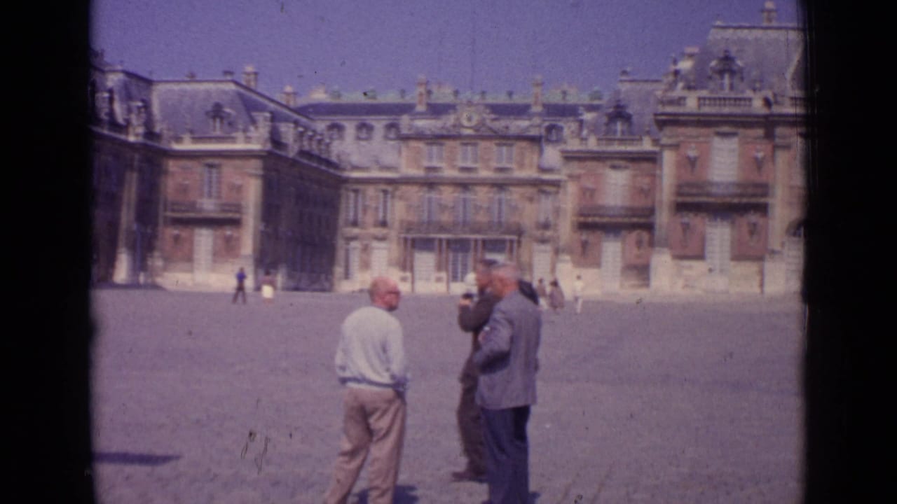 1962 Paris home-movie view of visitors standing and photographing in a grand paved square.