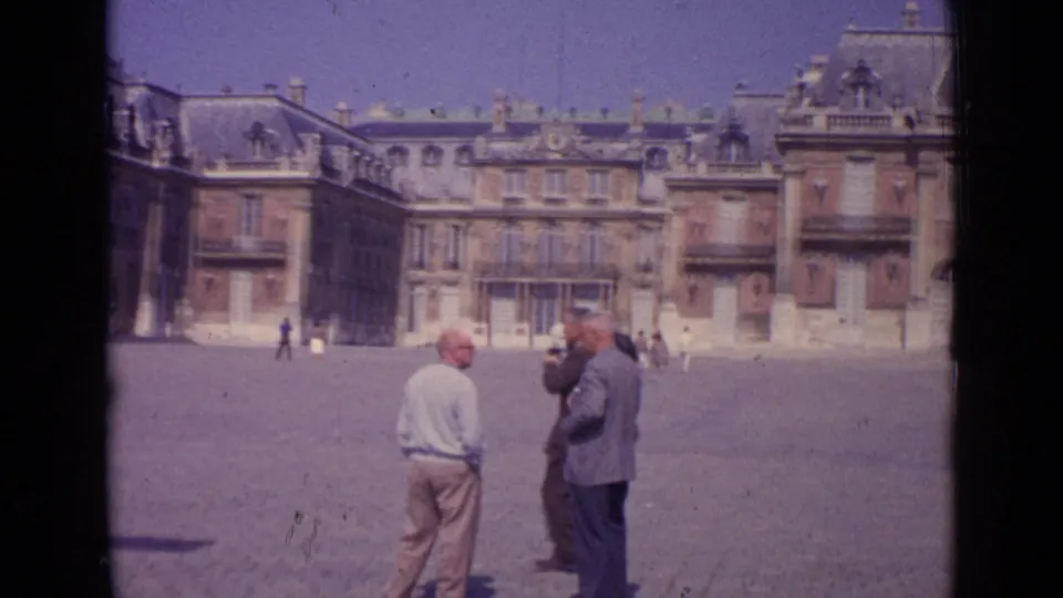 1962 Paris home-movie view of visitors standing and photographing in a grand paved square.