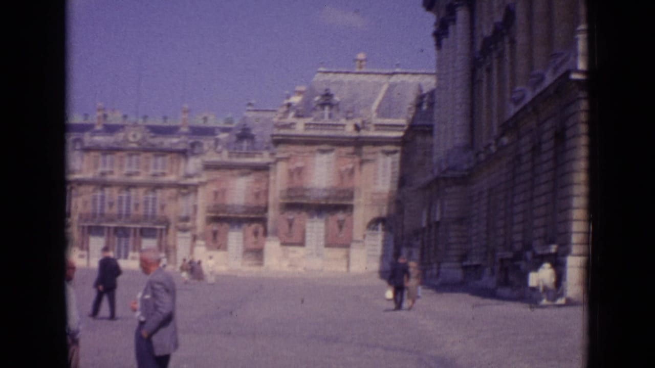 Wide palace courtyard with pedestrians and ornate stone facades.