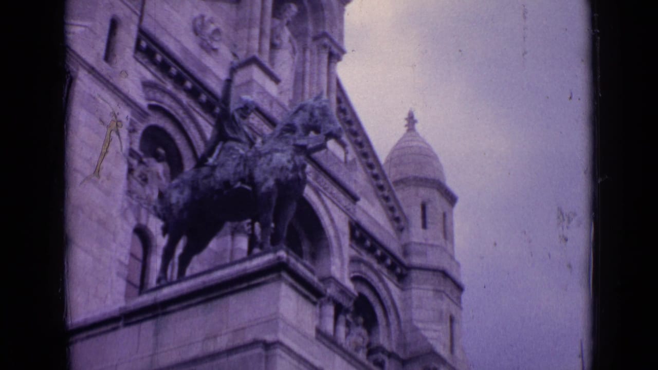 Paris landmark exterior detail with an equestrian statue, arched stone facade, carved ornament, and a domed tower visible above.