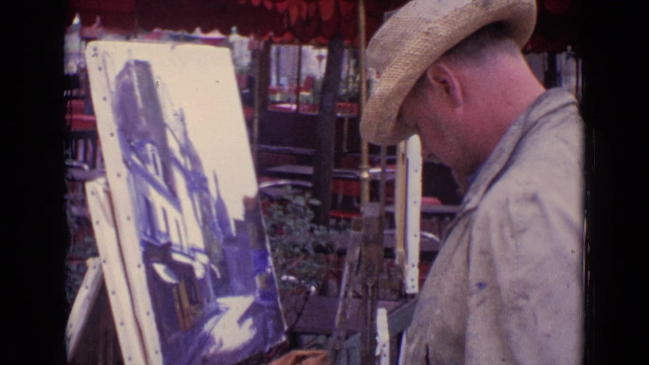 Street artist in a straw hat painting on an easel beside a Paris street.