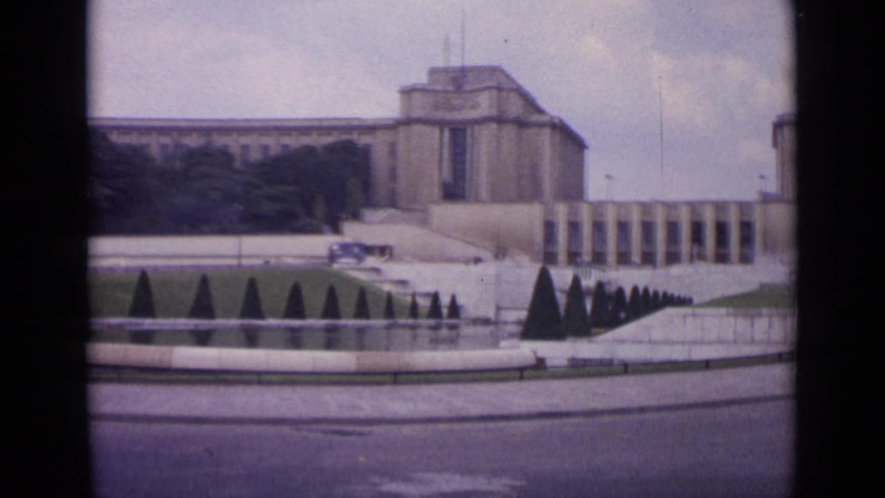 Palais de Chaillot and Trocadero fountain area with topiary and roadway in front.