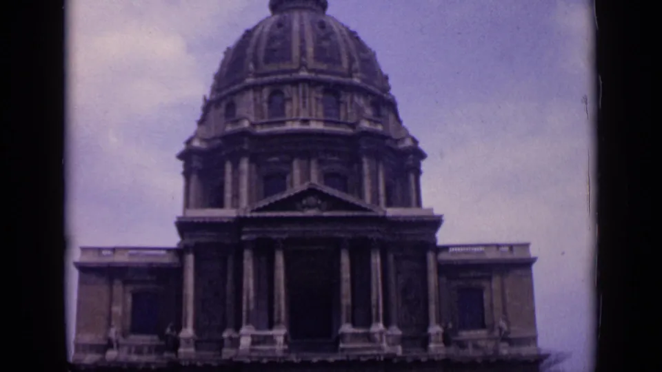 Wider 1962 Paris view of the Invalides dome, colonnade, pediment, and facade under a pale sky.