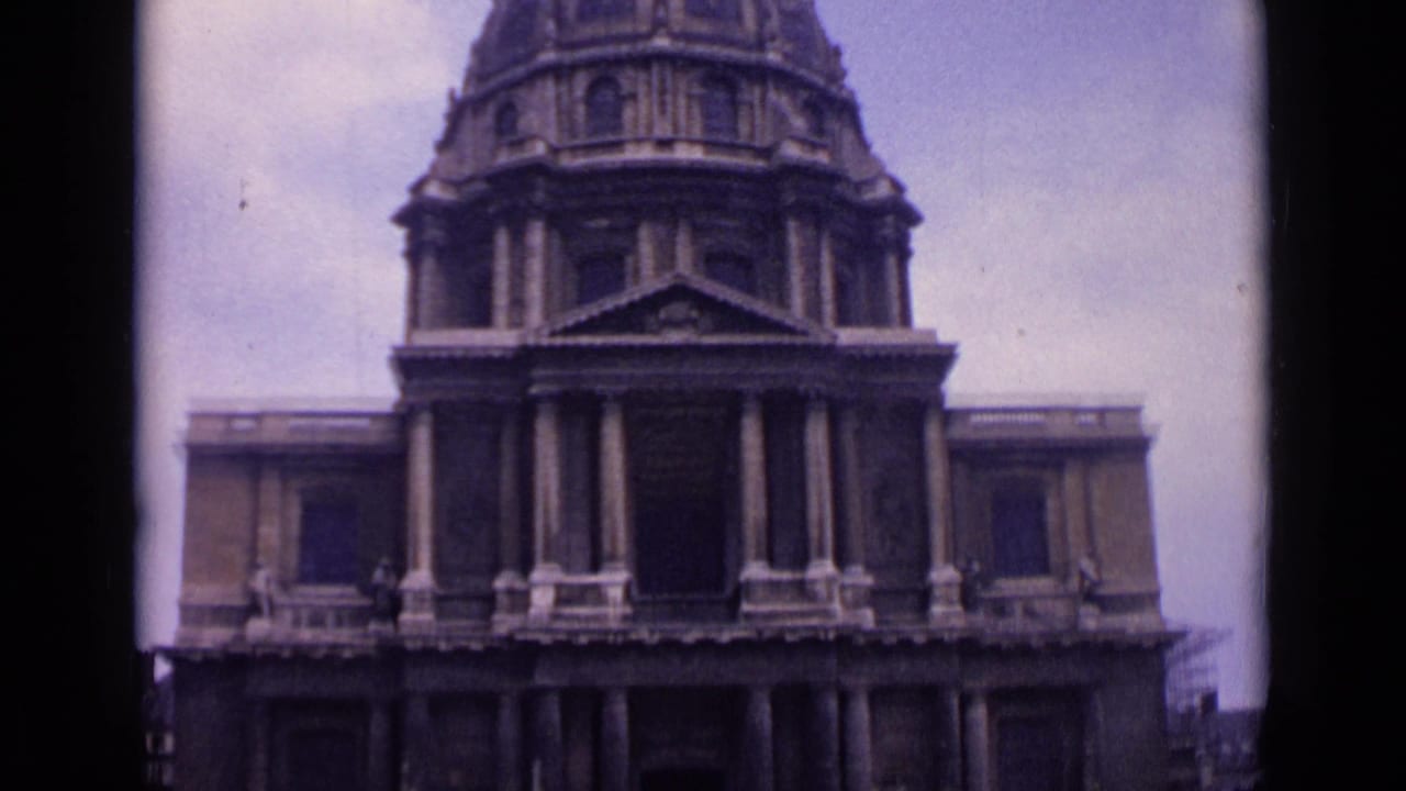 1962 Paris home-movie frame showing a domed historic facade with columns and a mostly empty public plaza.