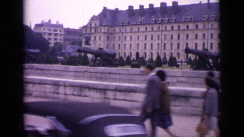 A wider 1962 Paris view shows a public square or terrace with cannons, pedestrians, cars, trees, and a large classical building beyond.
