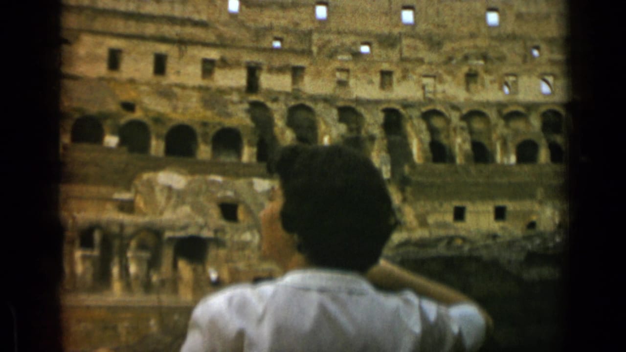 1962 Rome travel frame showing a woman from behind raising an arm while facing the Colosseum interior.