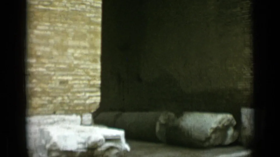 1962 Rome 8mm frame showing broken stonework and a dark masonry surface against old brick construction.