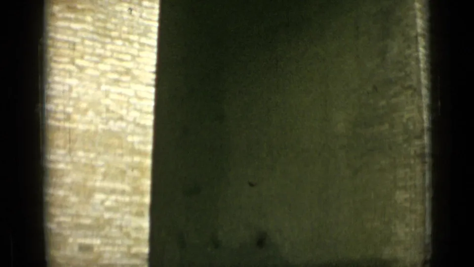 1962 Rome 8mm frame showing close masonry textures, with pale brickwork beside a darker vertical stone surface.
