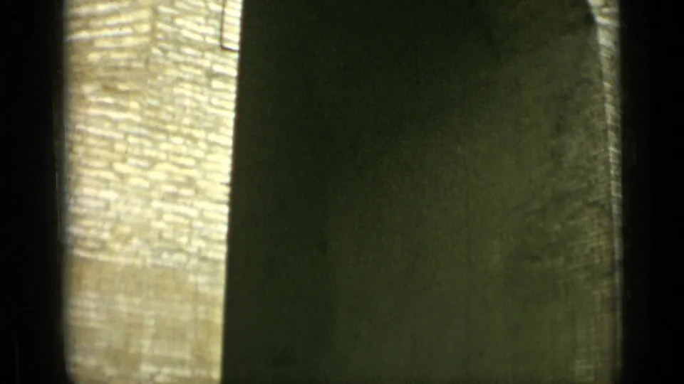 1962 Rome home-movie frame showing a close, soft-focus view of a rounded masonry arch and dark interior shadow.