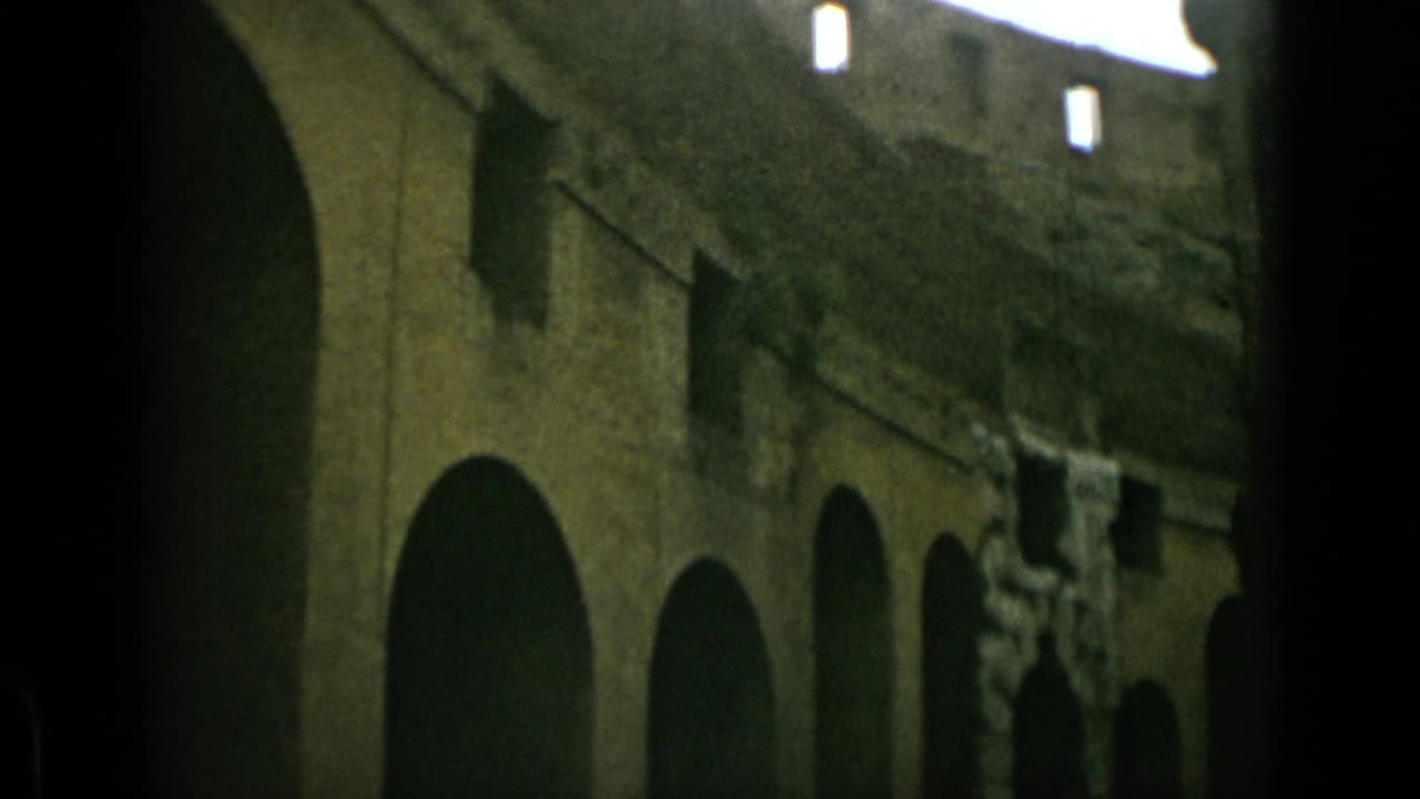 Low-angle view of dark stone arches inside the Colosseum ruins.