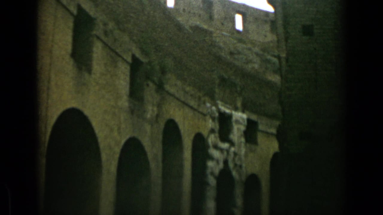 Dark arched openings and rough stonework seen from a low angle.
