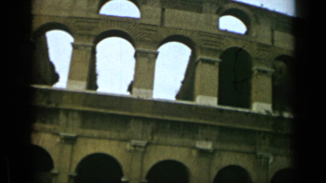 Close view of the Colosseum exterior with tall arched openings and dark film edges.