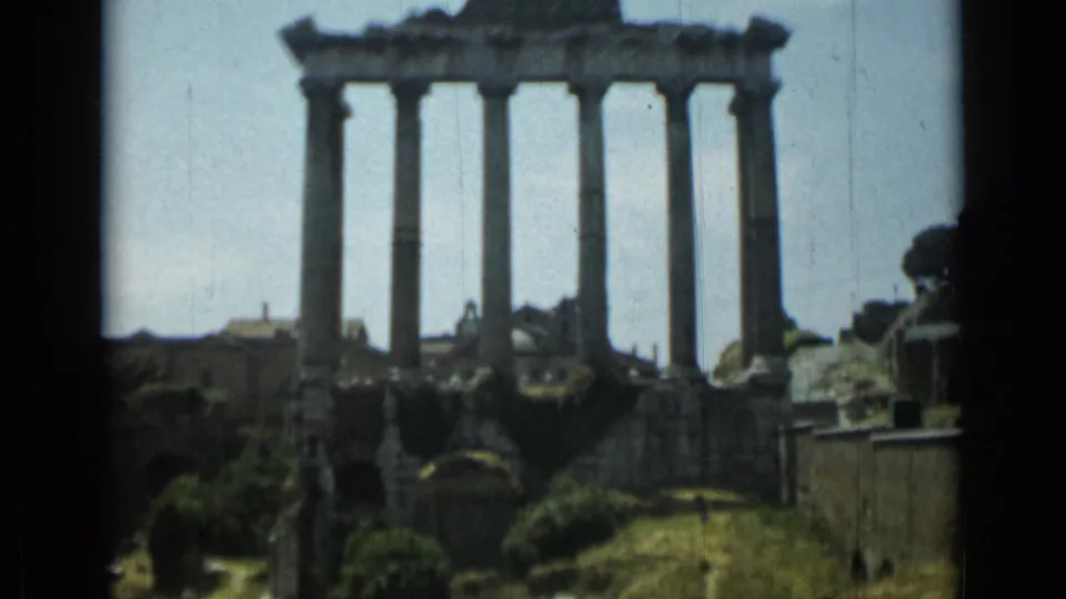 Rome 1962 home-movie view of ancient columns and ruined stonework under bright daylight.