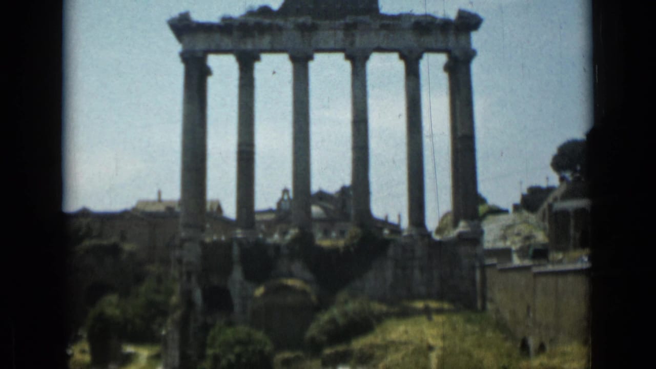 Ruined columns and stone structures under a bright sky.