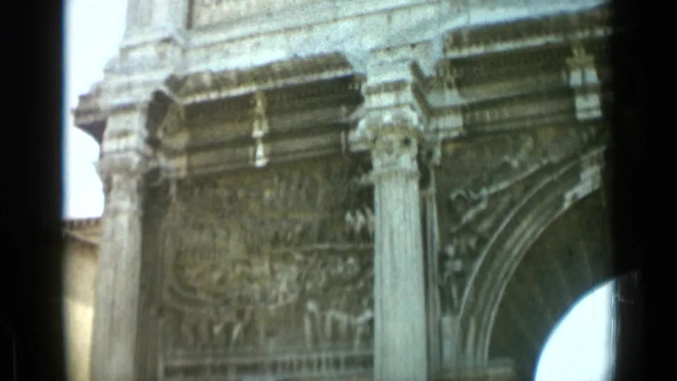 1962 Rome frame with a relief panel, vertical column, cornice, and part of an arch on the likely Arch of Constantine.