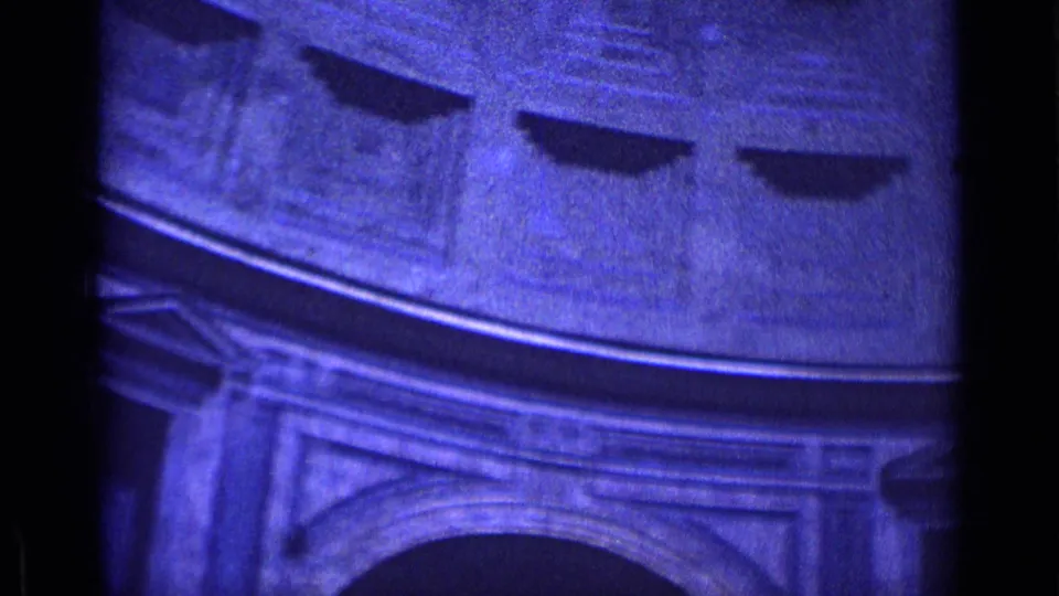 1962 Rome travel footage frame looking up at a circular interior with an arched opening, cornices, and dark recessed ceiling details.