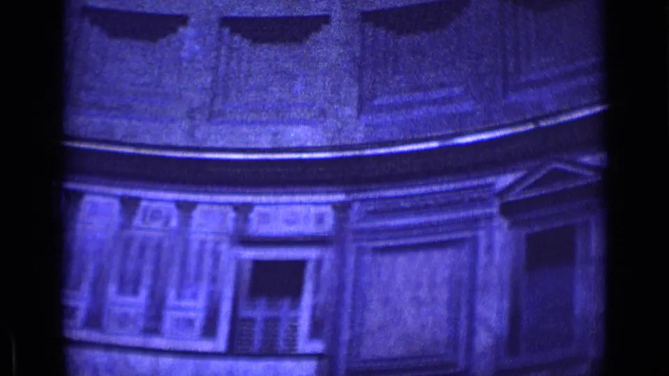 1962 Rome 8mm frame of a tall circular interior, with recessed panels, a doorway, and heavy grain from the home-movie scan.