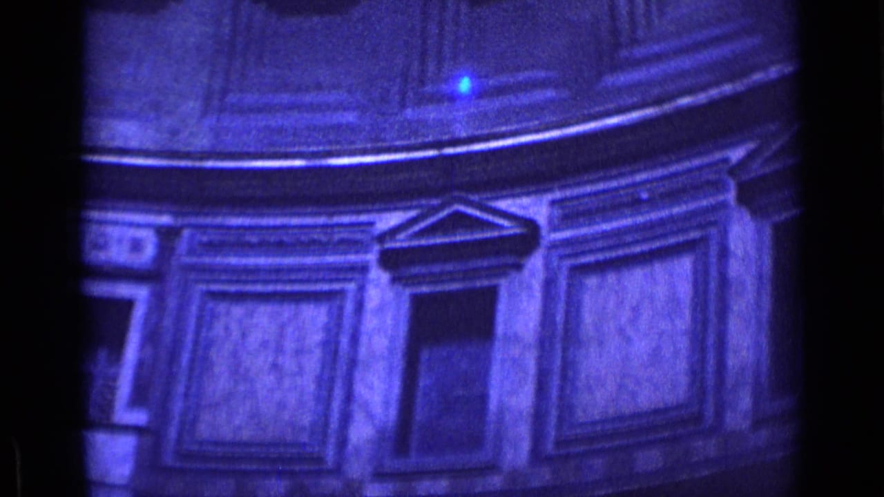1962 Rome 8mm frame showing blue-tinted classical interior details with framed panels, cornices, and a dark opening.