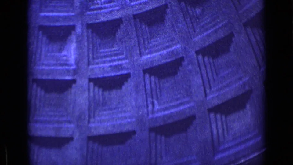 Blue-tinted Rome 1962 frame showing tilted coffered or paneled interior detail with deep shadows and visible film grain.