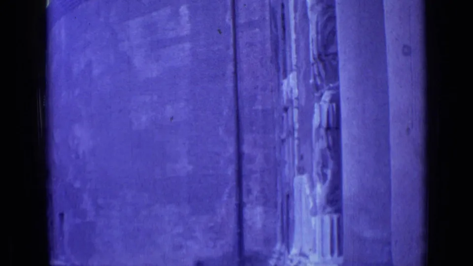 Rome 1962 home-movie frame showing a close facade detail, columns, and a carved figure-like architectural element at right.