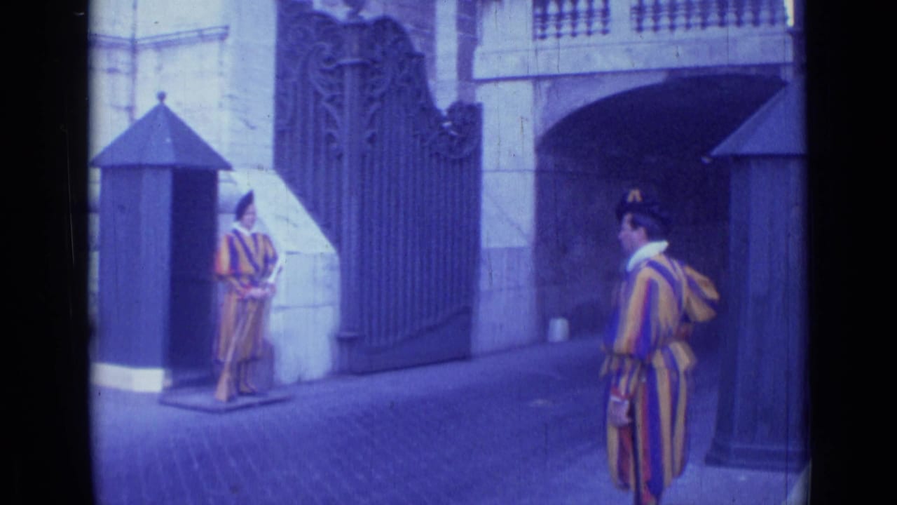 Ceremonial guards remain posted beside a gate and stone entrance.