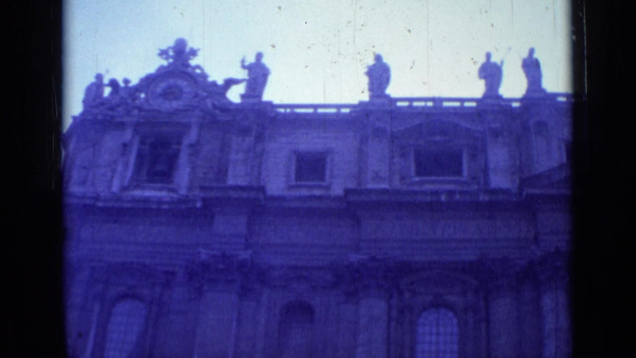 Low-angle view of an ornate basilica facade with roof statues and film borders.