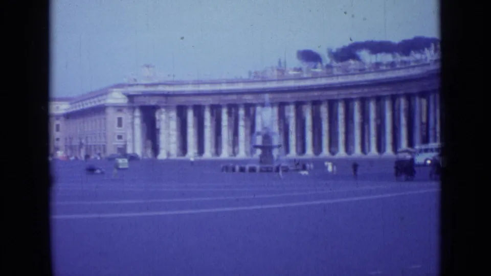 Rome landmark view with St. Peter's Square colonnade and fountain, filmed from a handheld 8mm travel perspective.