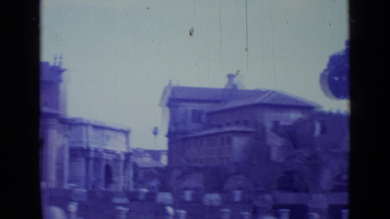 Soft 8mm view of stone buildings and a public area near Roman ruins.