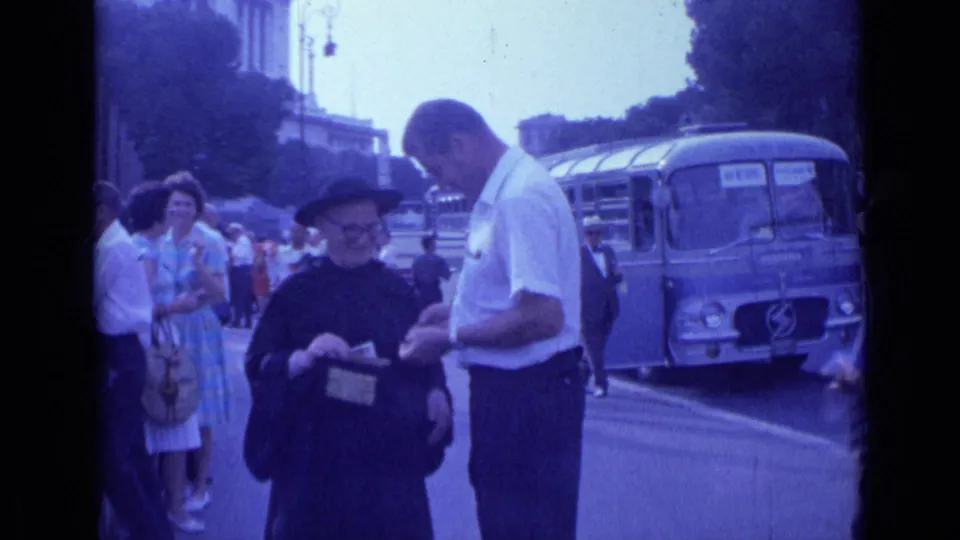 The 1962 Rome footage shows a man leaning toward a nun with a donation box, with women in dresses, onlookers, and a bus behind them.