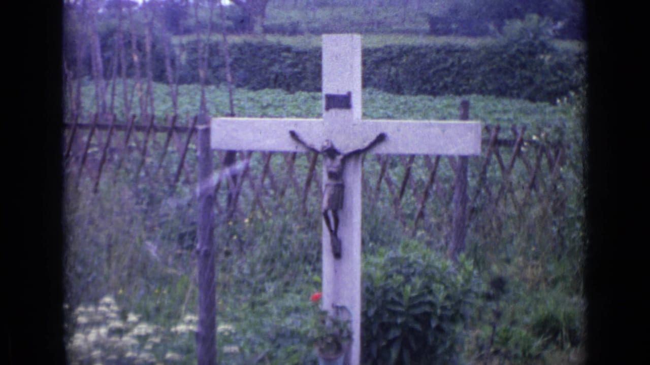 Crucifix on a garden cross seen from a slightly shifted angle.