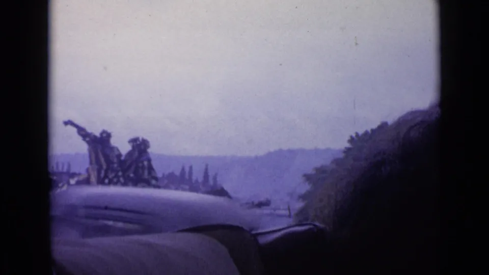 The final 1962 Switzerland frame shows a monument from a vehicle window, partly obscured by interior framing and a passenger silhouette.