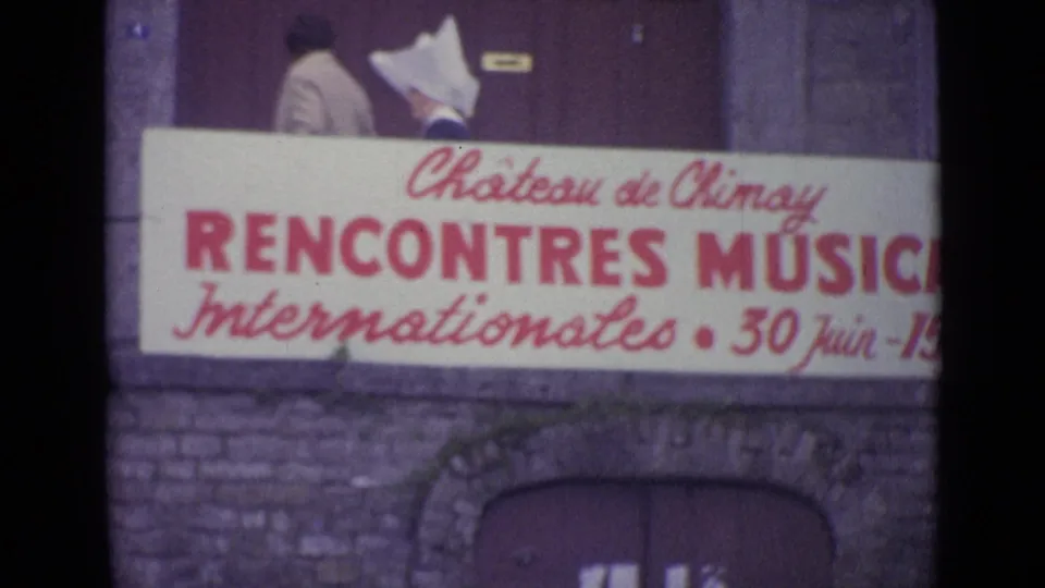 1962 8mm frame cataloged as Switzerland with the Château de Chiny Rencontres Musicales banner across an older stone exterior.
